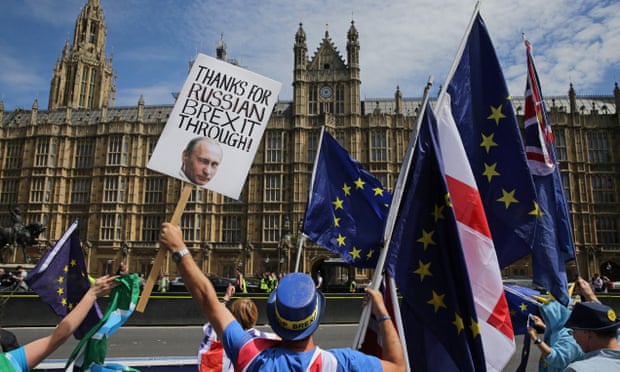 A pro-EU demonstrator holds a placard bearing an image of Russia’s President Vladimir Putin, during a protest outside of the Houses of Parliament on 11 June.
