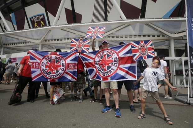 Fans pose for a picture outside London Stadium.