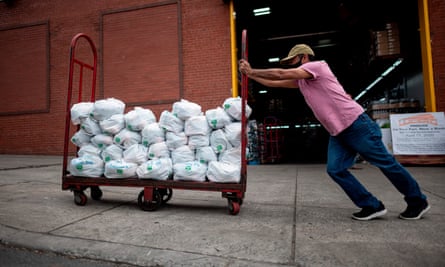 Unemployed construction worker Felix Pinzon pushes a cart of food delivery donations in the Bronx.