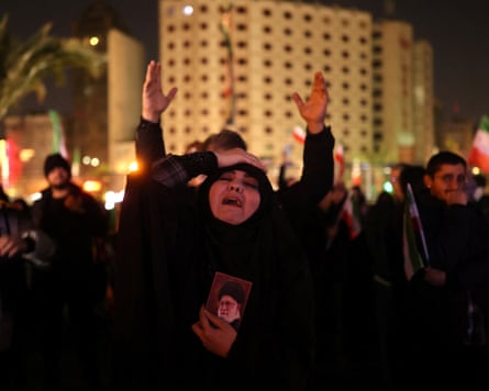 A woman holds a picture Ali Khamenei in Tehran