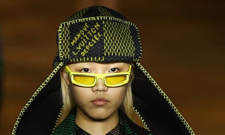 A model on the Louis Vuitton catwalk in sunglasses and hat.