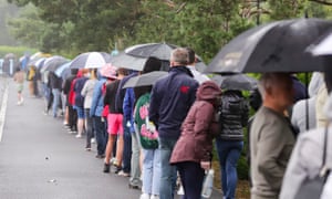 Parents and their children queue in the pouring rain outside the Citywest Covid-19 vaccination centre in Dublin.