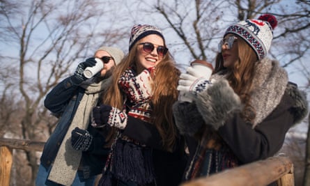 Friends in warm clothes meeting outside