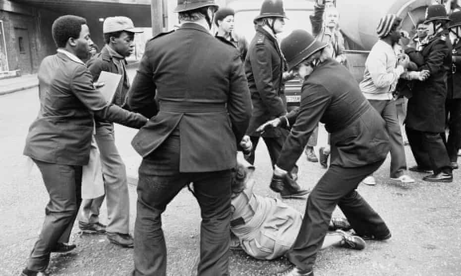 Police grab a woman at a London protest in 1981 against the handling of the investigation into a fire in Deptford, in which 13 black people died.