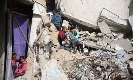 Palestinians gather to inspect damage of the destroyed building belonged to the Dhaheer family, following an Israeli attack on the Rafah, Gaza on March 27, 2024.