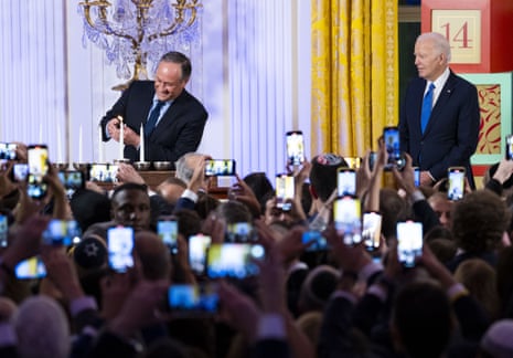 Joe Biden looks on as second gentleman Douglas Emhoff, husband of vice-president Kamala Harris, lights the menorah