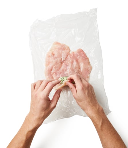 Unwrap one piece of the chilled butter and place it near the short edge of one of the butterflied breasts. Bring the edge over the top of the butter, then roll up into a tight sausage, using the clingfilm to help you and tucking in the ends as you go; if they pop out, glue them with a paste of beaten egg and flour. Repeat with the second breast.