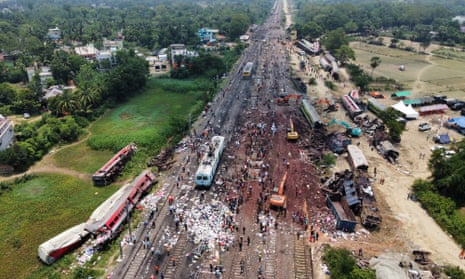 A drone view shows diggers removing damaged coaches following Friday’s train crash in the eastern Indian state of Odisha.