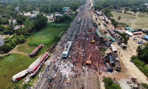 Diggers remove damaged coaches following Friday’s India train crash in the state of Odisha
