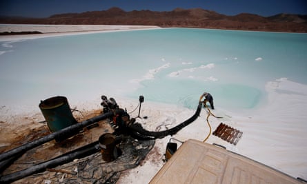 A worker cleans a pipe at a brine pool of the Rockwood lithium plant on the Atacama salt flat.