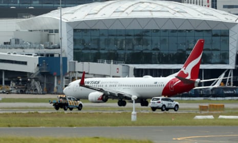 QF144 lands as emergency crews follow at Sydney International Airport in Sydney