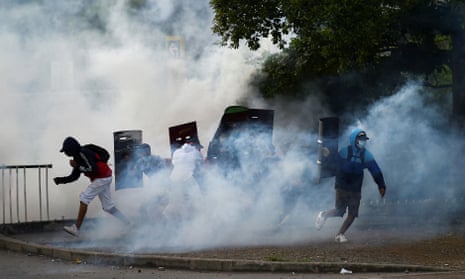 Teargas rises around demonstrators in Cali, Colombia.