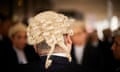 A barrister wearing a wig is seen from behind