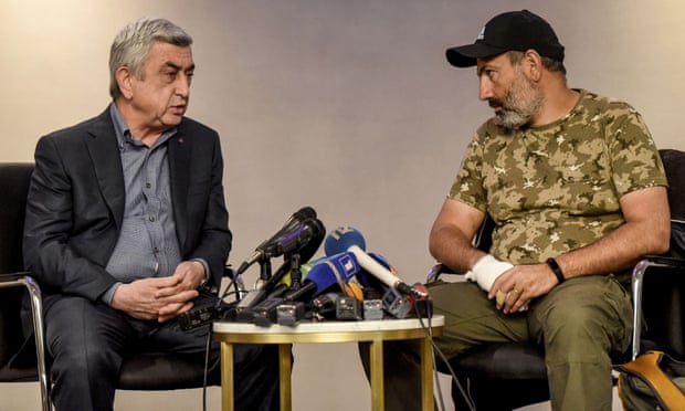 The new Armenian PM Serzh Sarksyan, left, debates Nikol Pashinyan in a televised encounter, shortly before Sarksyan, an opposition leader, was detained.