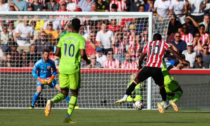 Brentford's Josh Dasilva scores their first goal.