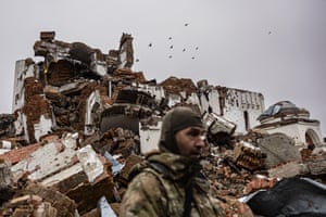 Caesar, a 50-year-old Russian who joined the Freedom of Russia Legion to fight on the side of Ukraine, stands in front of a destroyed monastery in Dolyna