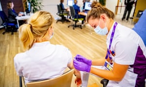 A healthcare workers receives a Pfizer booster vaccine in Dordrecht, the Netherlands.