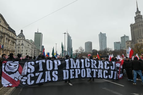 Participants carry flags during the Independence March commemorating the 107th anniversary of Poland’s return to sovereignty, in Warsaw, Poland.