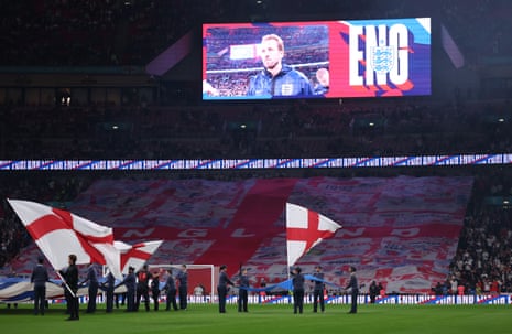 Harry Kane of England is shown on the big screen as the teams walk out.