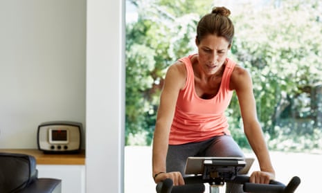 woman on exercise bike in airy living space