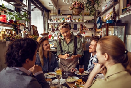 A close up of a group of friends having brunch in a restaurant.