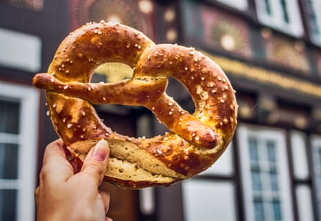 Pretzel and a typical German house in the background, in Lower Saxony