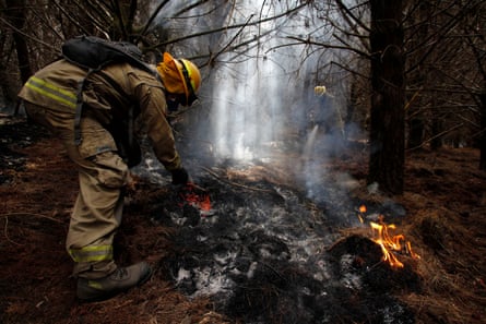 Firefighters try to put out a forest fire in Latacunga, Cotopaxi Province, Ecuador, on 27 September 2024.