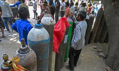 People wait to refill their oxygen cylinders in Delhi.
