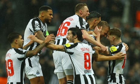 Newcastle United's Dan Burn celebrates scoring their second goal with teammates during the Champions League Group F football match between Newcastle United and Paris Saint-Germain at St James’ Park.