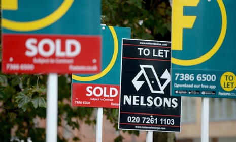 A cluster of estate agent signs advertising properties for sale and to rent