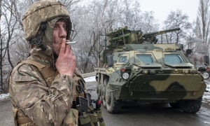 A Ukrainian soldier smokes a cigarette on his position at an armored vehicle outside Kharkiv, Ukraine on Saturday.