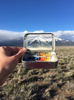 Heidi Annalise paints panoramic landscapes into small mint tins.