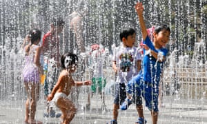 Children play in water jets at a park in Tokyo in 2018 as the temperature rose up to 39.6 degrees Celsius.