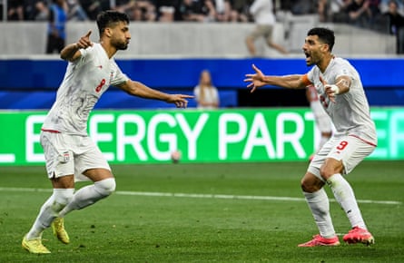 Mohammad Mohebi of the IR Iran celebrates his goal with Mehdi Taremi