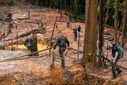 French gendarmes and members of the World Wildlife Fund at an illegal gold panning site south-west of Cayenne, French Guiana, 2019