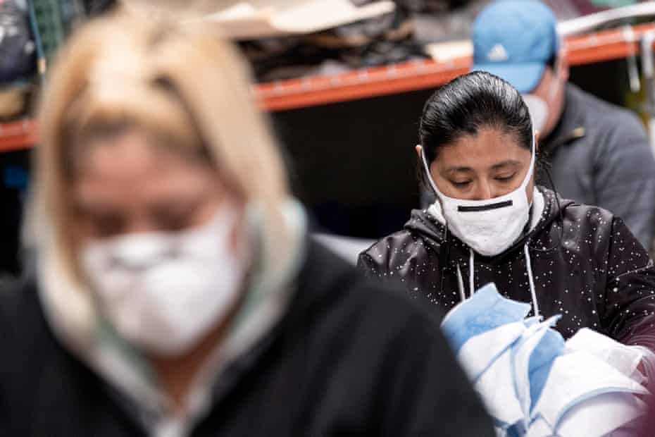 Workers at a sewing shop in Los Angeles wear masks as they make masks for local hospitals. 
