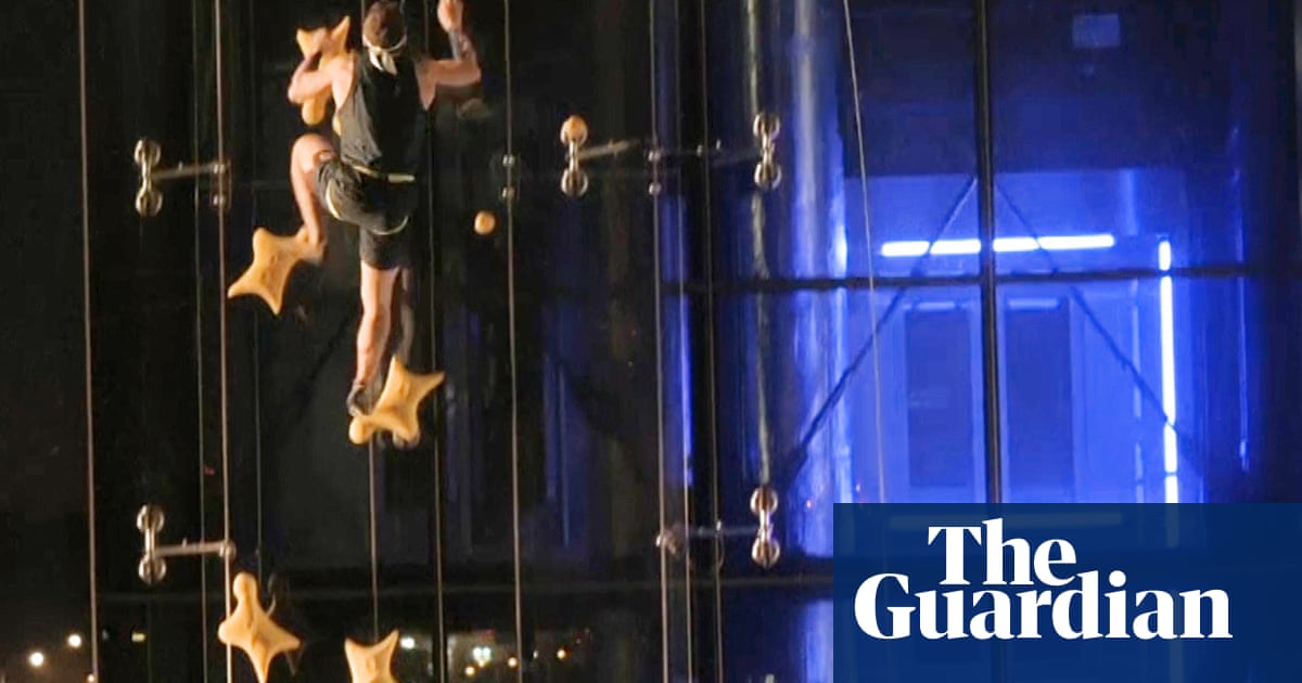 Speed climber takes on lift in six-storey sprint ... and wins – video