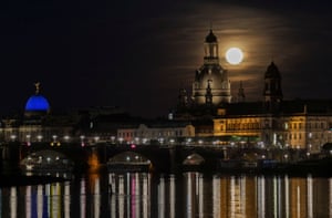 The moon rises over the old town district in Dresden, Germany