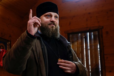 Ukrainian priest Serhii Palamarchuk is seen after celebrating mass in a church with boarded windows to protect it from shelling in Kostyantynivka.