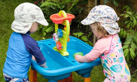 two toddlers playing in garden