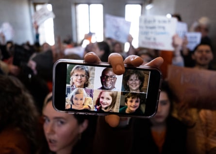A demonstrator displays a picture of the victims of the Covenant School shooting on their phone inside the Tennessee state capitol during a protest against gun violence on Thursday in Nashville, Tennessee.