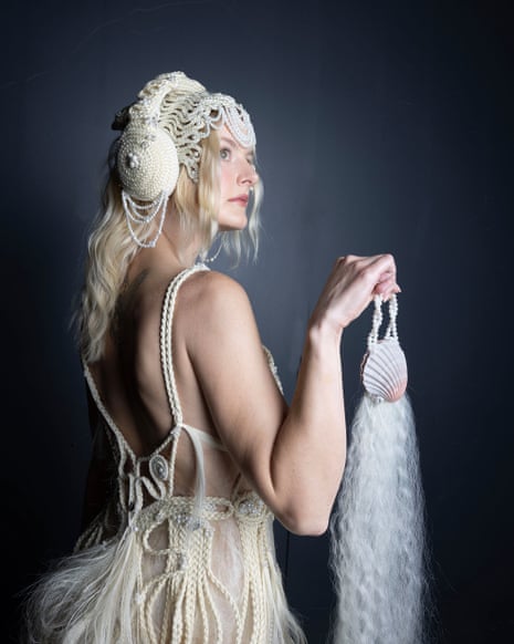 Blond woman wearing a dress and holding a bag made out of blond hair