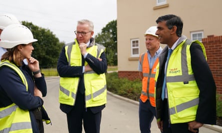 Rishi Sunak, right, and Michael Gove, centre, visit a housing development in Norwich on 29 August 2023.