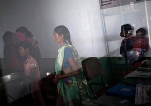 Women who underwent sterilisation surgery queue to receive food inside a hospital in the eastern Indian state of Chhattisgarh, in November 2014