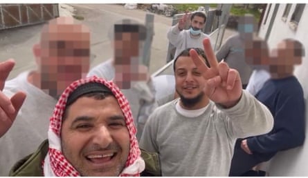 A group of men pose for a selfie, some of their faces have been pixellated