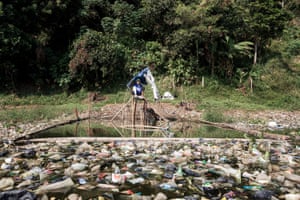 A fish trap on the river bank. The fishermen have to build floating fences and fish among the rubbish.