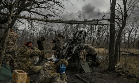 Ukrainian servicemen fire towards Russian positions near the city of Bakhmut.