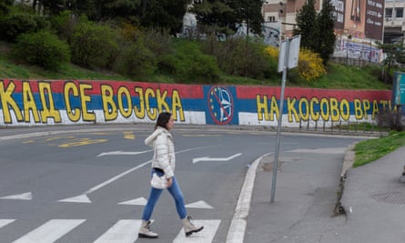 Graffiti reading ‘When the army returns to Kosovo’, along with a crossed out combination of the Nato and the EU logo, on a wall in Belgrade.