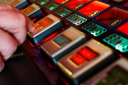 A customer plays on a slot machine in a casino. Online games are hugely profitable for gambling companies with new legislation now in the offing.