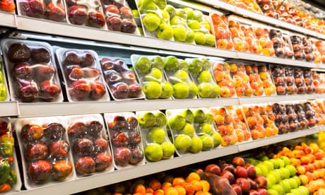 fruits are wrapped in plastic on shelves in a store